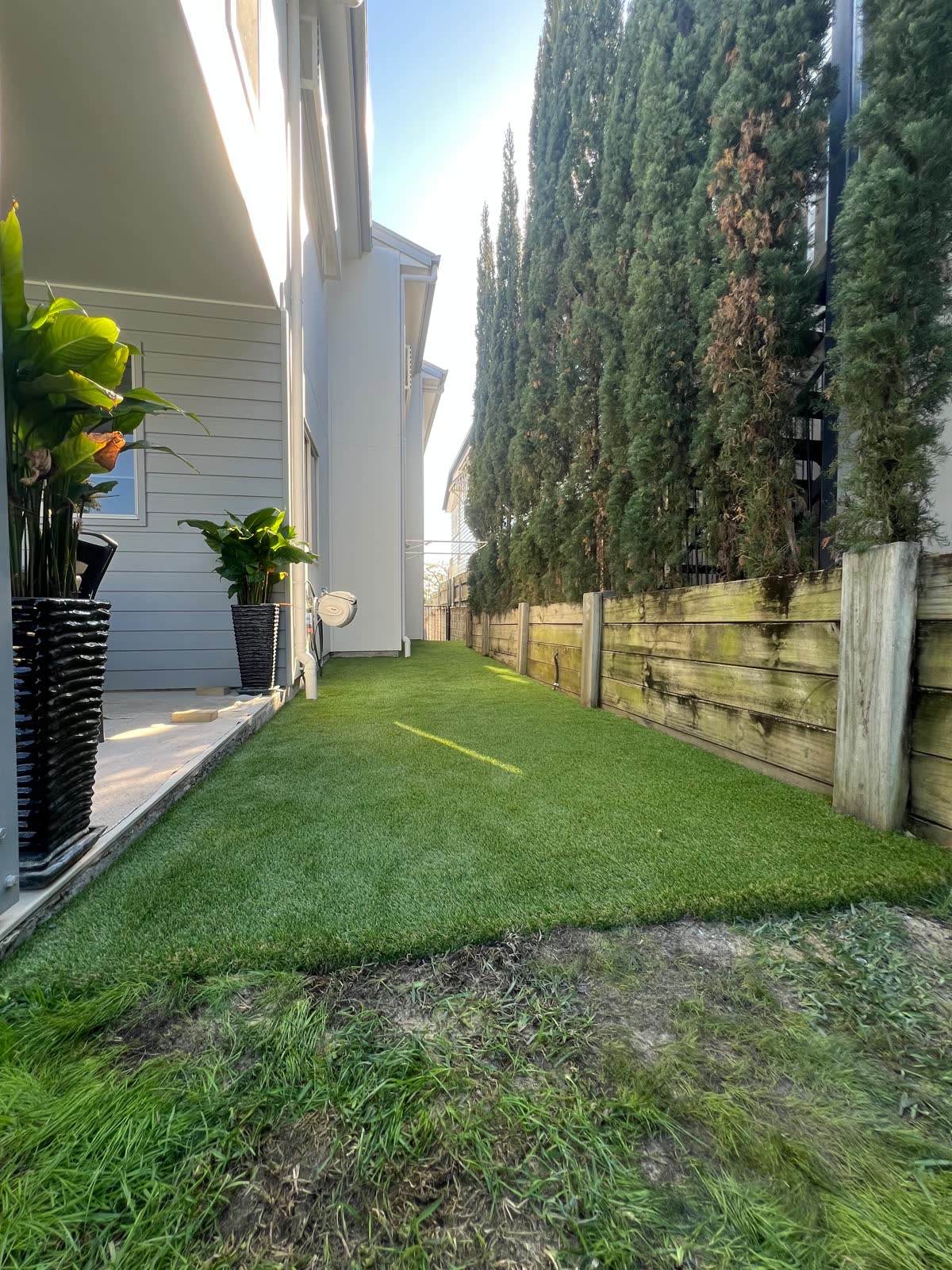 After: finished synthetic turf in the side passage